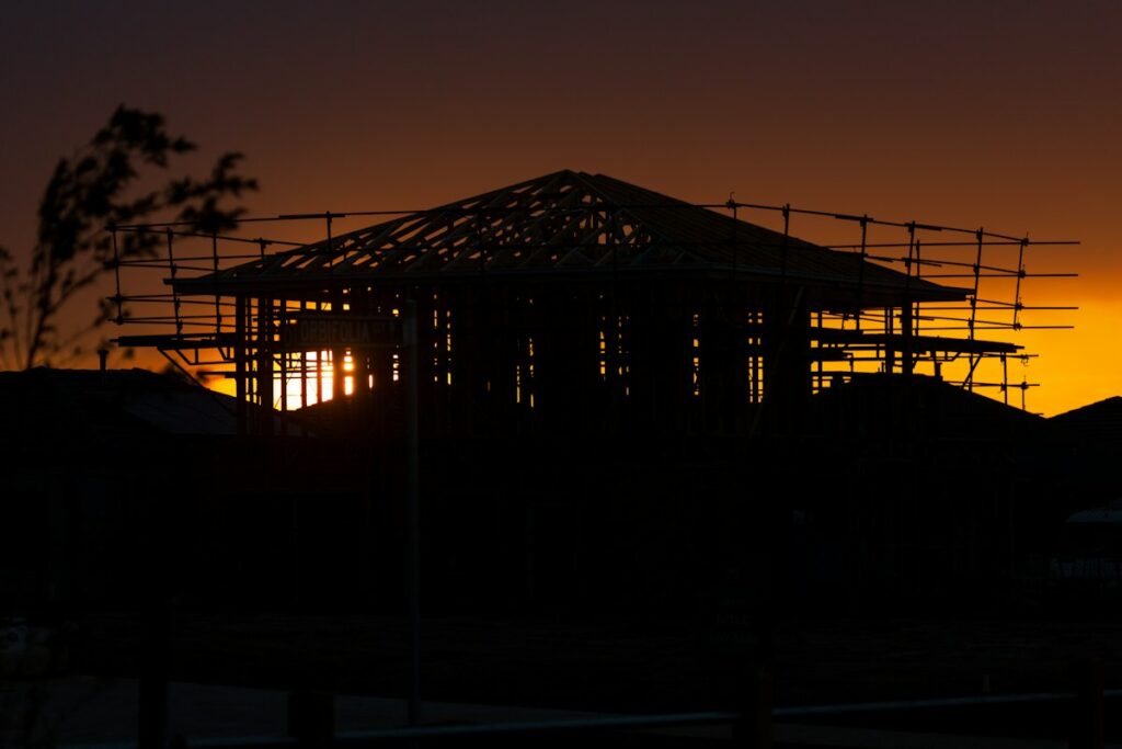 Construction crew at work on a job site at sunrise, representing builder business consulting in Alabama